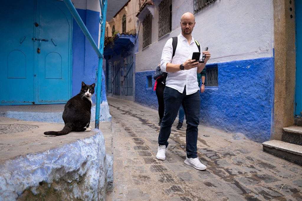 cat and a tourist in the medina of Chefchaouen